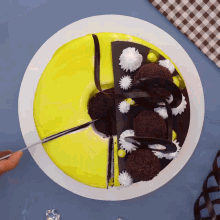 a yellow and chocolate cake with a slice cut out of it