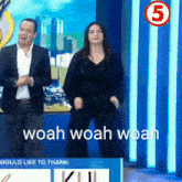a man and a woman are dancing in front of a sign that says would like to thank