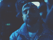 a man wearing a bandana and sunglasses looks down