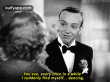 a black and white photo of a man in a tuxedo talking to another man .