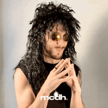 a man wearing a wig and sunglasses has the word mcdh on the bottom