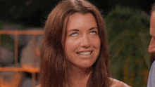 a woman is smiling and looking up at the camera