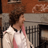 a woman wearing headphones and a t-shirt that says fight it