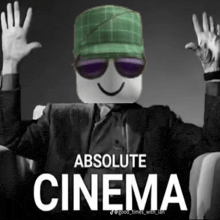 a man wearing a green hat and sunglasses is sitting in a chair with the words absolute cinema above him