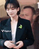 a woman wearing a black jacket and a white shirt is standing in front of a sign that says " viggle.ai "