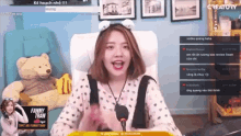 a woman is sitting in a chair with a microphone in front of a screen that says creatory on it