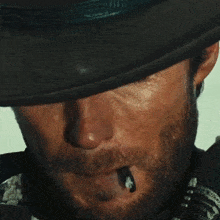 a close up of a man 's face with a hat on
