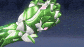 a close up of a green and white glove with a pink flower on it