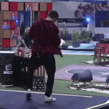 a man in a red shirt is dancing on a stage in front of a big 21 sign