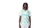 a man wearing a hofmann shirt and shorts stands in front of a white background