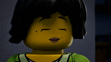 a close up of a lego girl with black hair and a green shirt