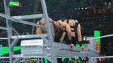 wrestlers in a wrestling ring with the letters w on the bottom left