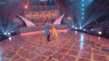 a man and woman are dancing on a dance floor with rose petals on the floor