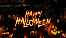 pumpkins are lit up in front of a sign that says " happy halloween "