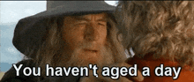 a man with a beard and a hat is talking to another man and says `` you haven 't aged a day ''