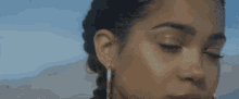 a close up of a woman 's face with earrings