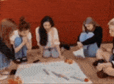 a group of young women are sitting around a table