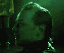 a close up of a man 's face with a dark background