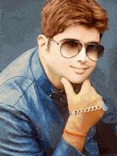 a young man wearing sunglasses and a leather jacket