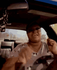 a woman wearing a mickey mouse shirt is sitting in a car