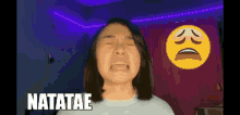 a woman is crying in front of a sad smiley face and the word natatae is above her