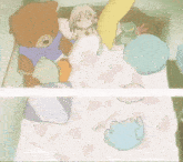 a teddy bear wearing a blue shirt is sitting on a bed with other stuffed animals