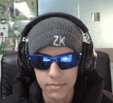 a young man wearing headphones and a beanie with the letter z on it