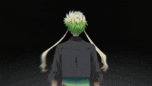 a man with a green bandana on his head stands in front of another man