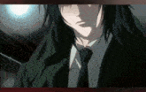 a man with long black hair is wearing a green jacket and a black tie
