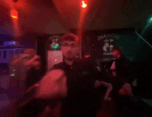 a blurry picture of people dancing in a dark room with red lights