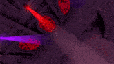 a red light is shining on a purple wall