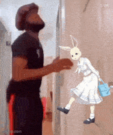 a man is standing next to a cartoon rabbit holding a watering can .