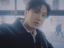 a young man is taking a selfie on a bus .