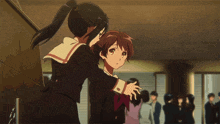 a girl in a school uniform is hugging another girl in a room