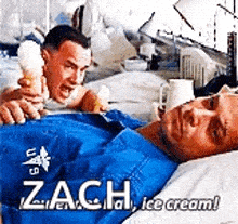 a man is laying in a hospital bed while another man holds an ice cream cone over his head .