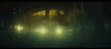 a blurred image of a person 's eyes with a yellow light behind them