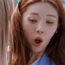 a close up of a woman making a funny face with her mouth open