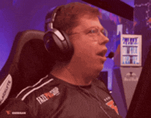 a man wearing headphones and glasses is sitting in a chair