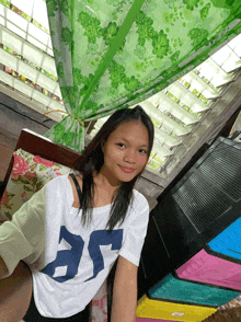 a young girl wearing a white shirt with the number 35 on it