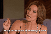a woman is sitting on a couch and says that 's not the kind of princesses i know