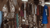 a bunch of clothes are hanging on a rack in a store
