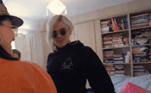 a woman wearing a black sweatshirt with a triangle on the front