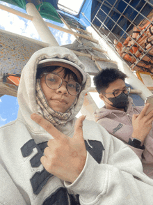 a person wearing a hoodie with the letter e on it