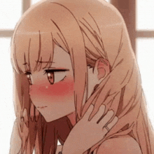 a close up of a blonde anime girl with long hair covering her face with her hands .