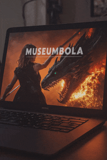 a laptop with a picture of a woman and a dragon and the words museumbola