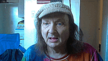 an elderly woman wearing a hat and a colorful shirt