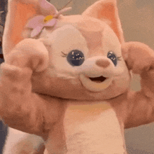 a stuffed animal with a flower in its hair is flexing its muscles and smiling .