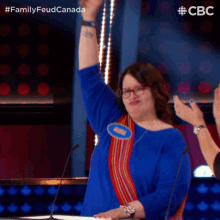 a woman in a blue shirt with a name tag that says ginny