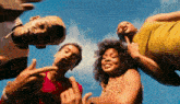 a group of people are standing in a circle and looking up at the sky