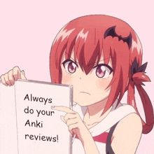 a girl is holding a piece of paper that says always do your anki reviews